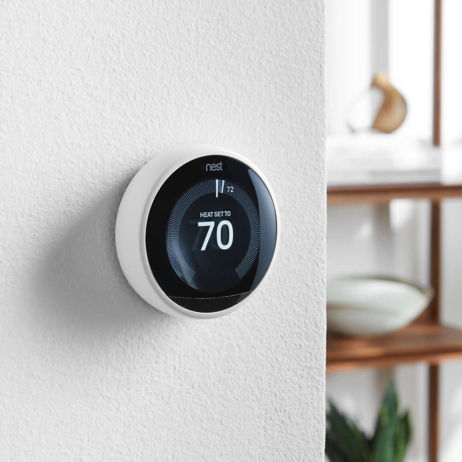 Nest programmable thermostat on a wall