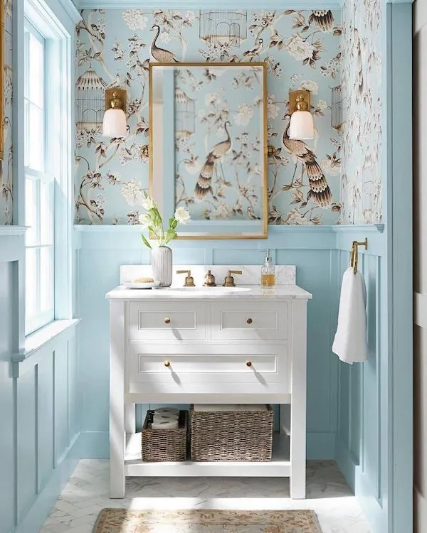 Pale blue wallpaper with birds in a powder room