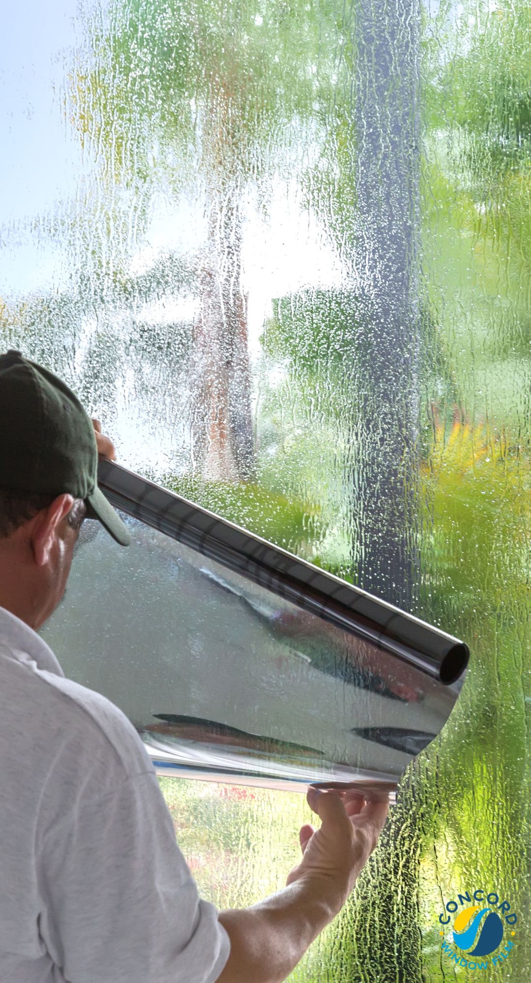 Man installing window film in a home