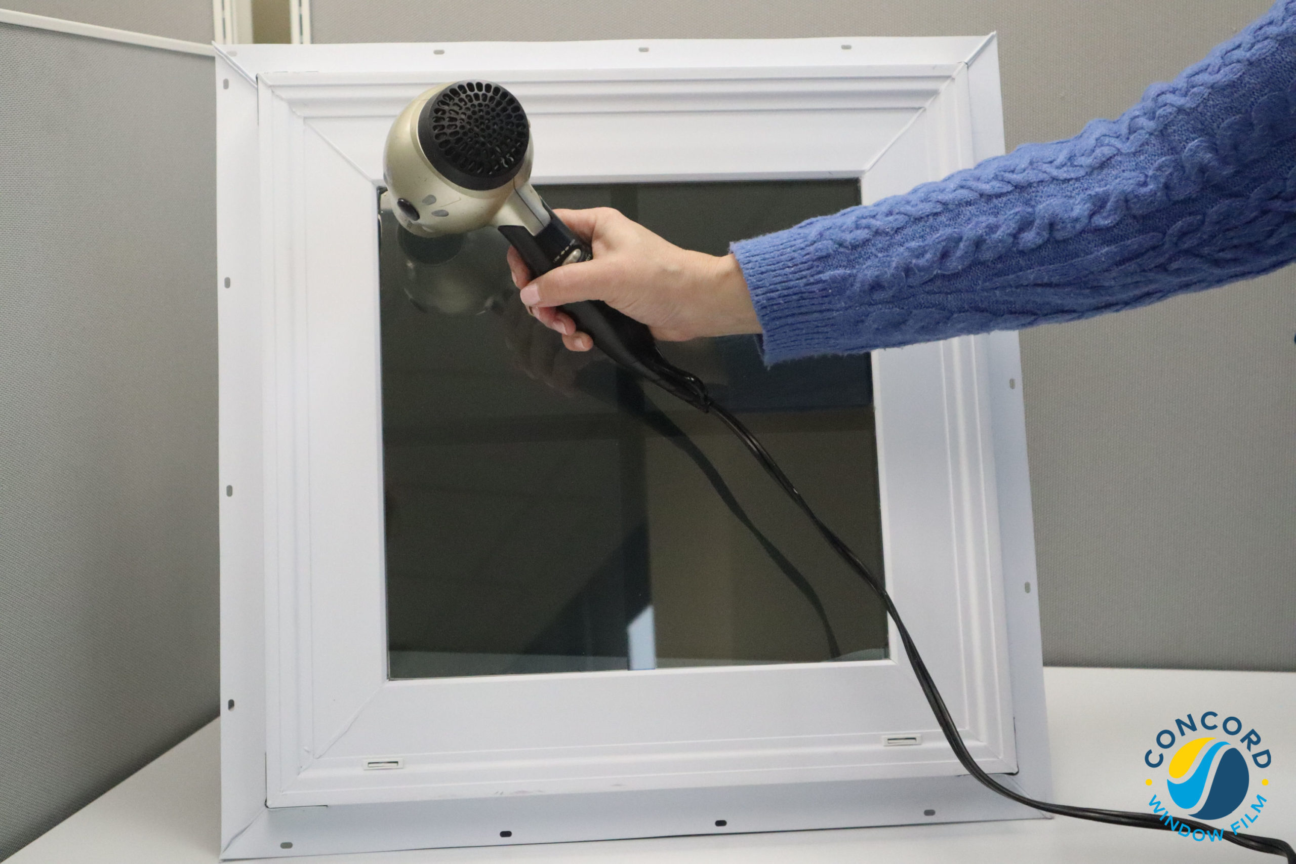 Using a hairdryer to loosen window film adhesive