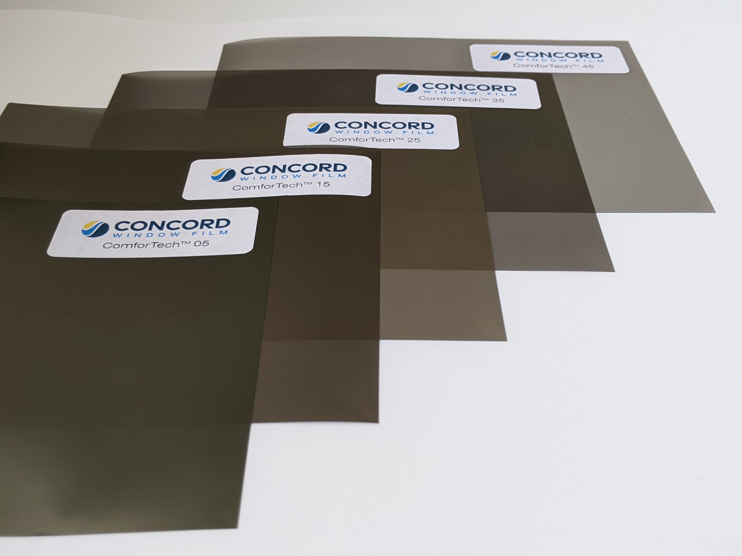 ComforTech Ceramic Series Window FIlm samples laid out from darkest to lightest to show the color or shade variation