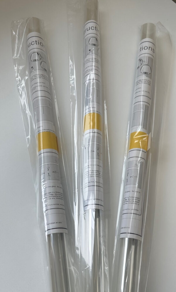 Three rolls of 4mil safety window film packaged up with instructions