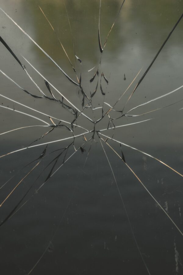 Photo of broken window glass with cracks in glass
