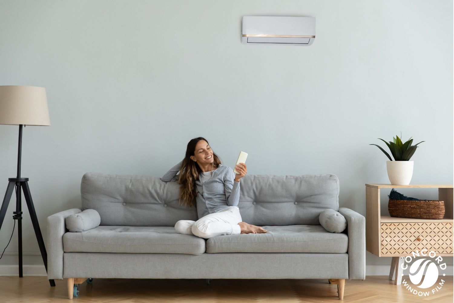 Woman on a couch enjoying air conditioning
