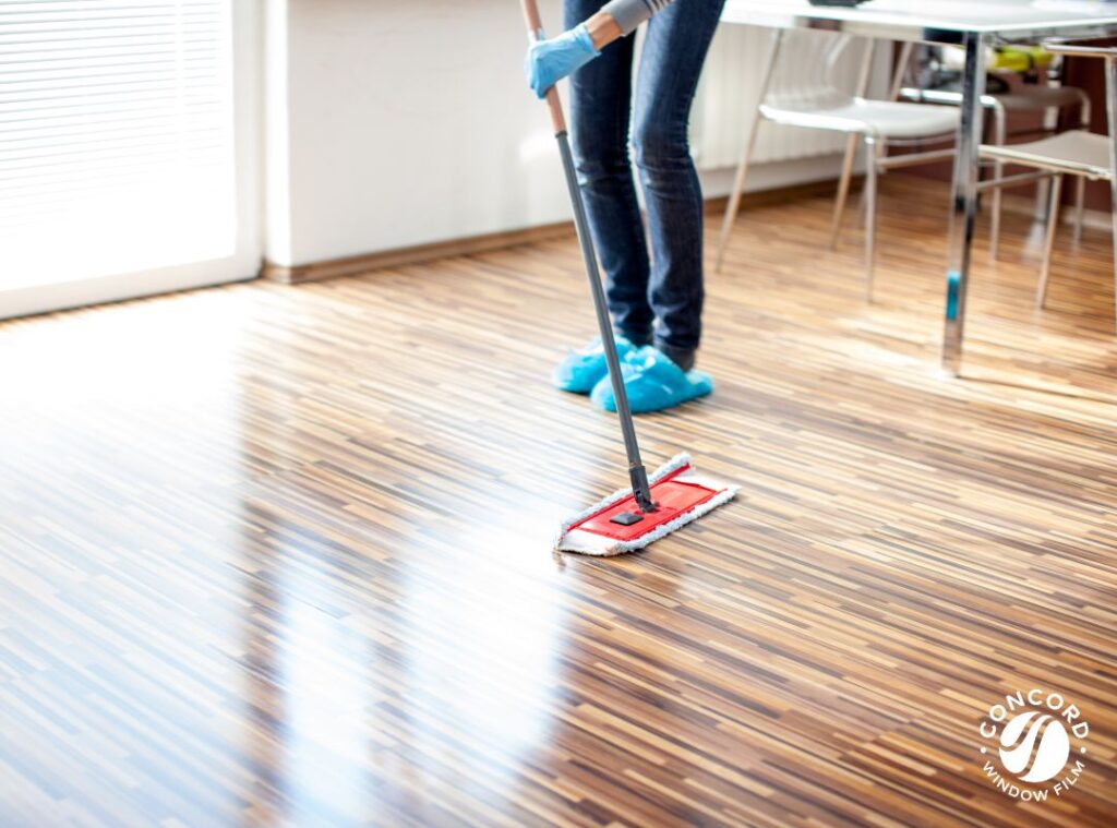 Photo of a woman mopping a floor to care for hardwood floors