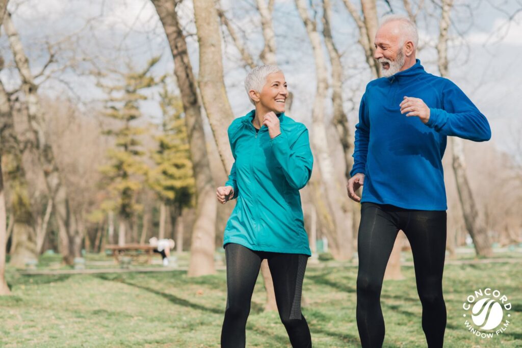 A photo of a couple power walking in a park to illustrate the importance of exercise for good sleep hygiene