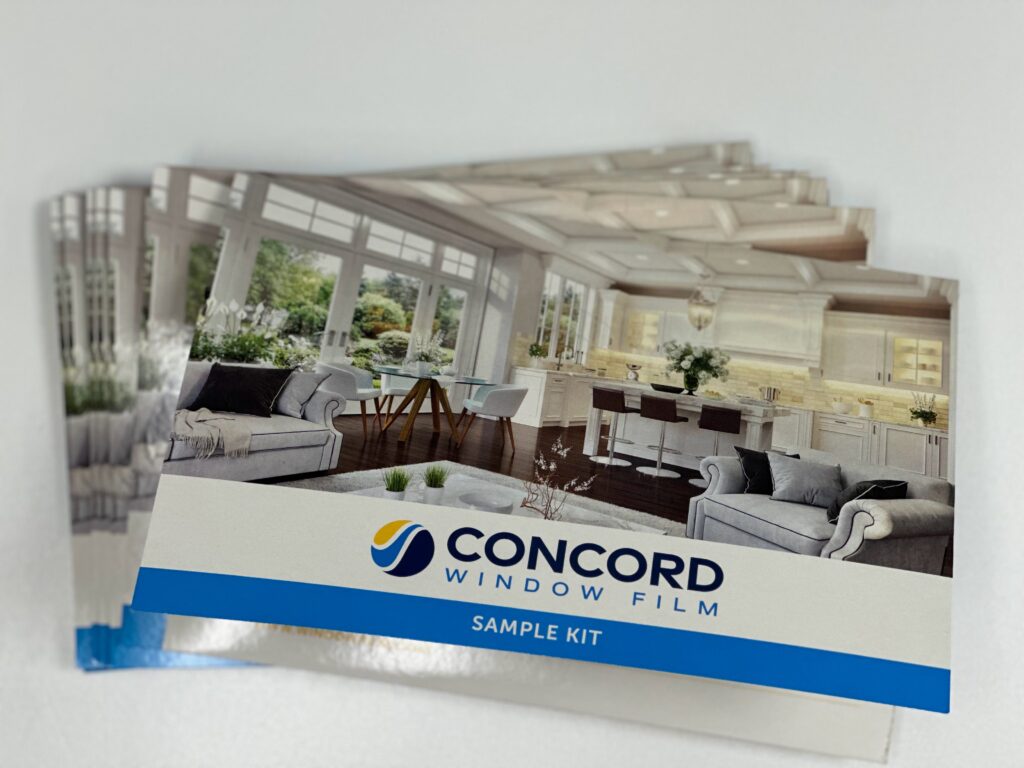A stack of window film sample kits from Concord Window Film