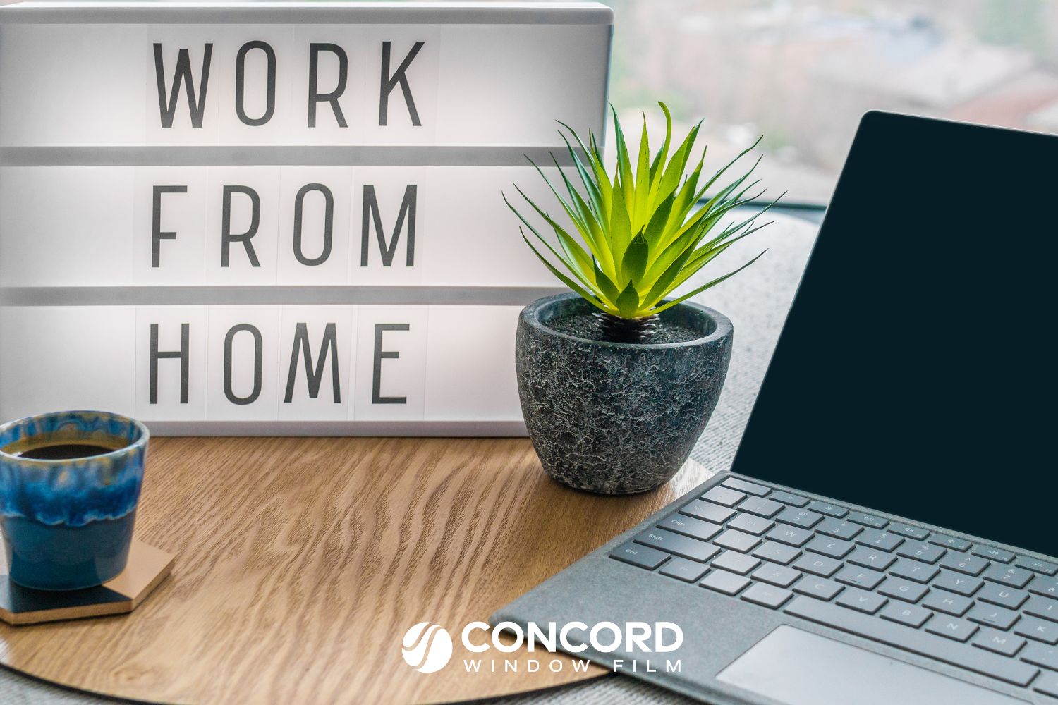 Laptop and Work deom Home sign on a desk