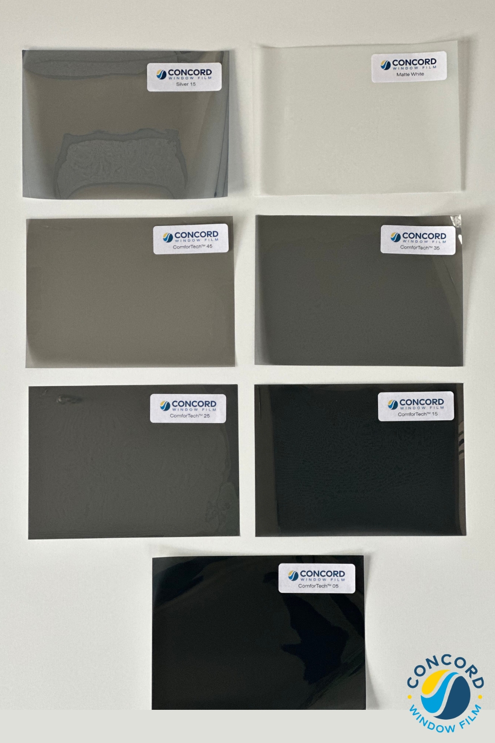 All seven of Concord Window FIlm's different window films laid out on a table to see the colors