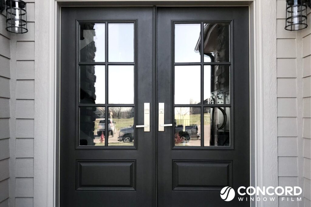 A set of double front doors with 3/4 lite glass with transparent privacy film installed for a post on front door privacy ideas on Concord Window Film's blog.
