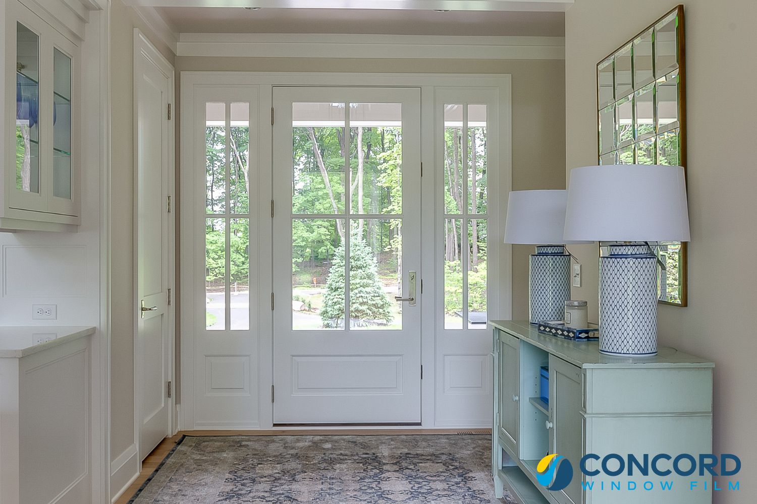 A beautiful front foyer with large entry doors with sidelights for a blog post on front door privacy ideas on Concord Window Film's blog.