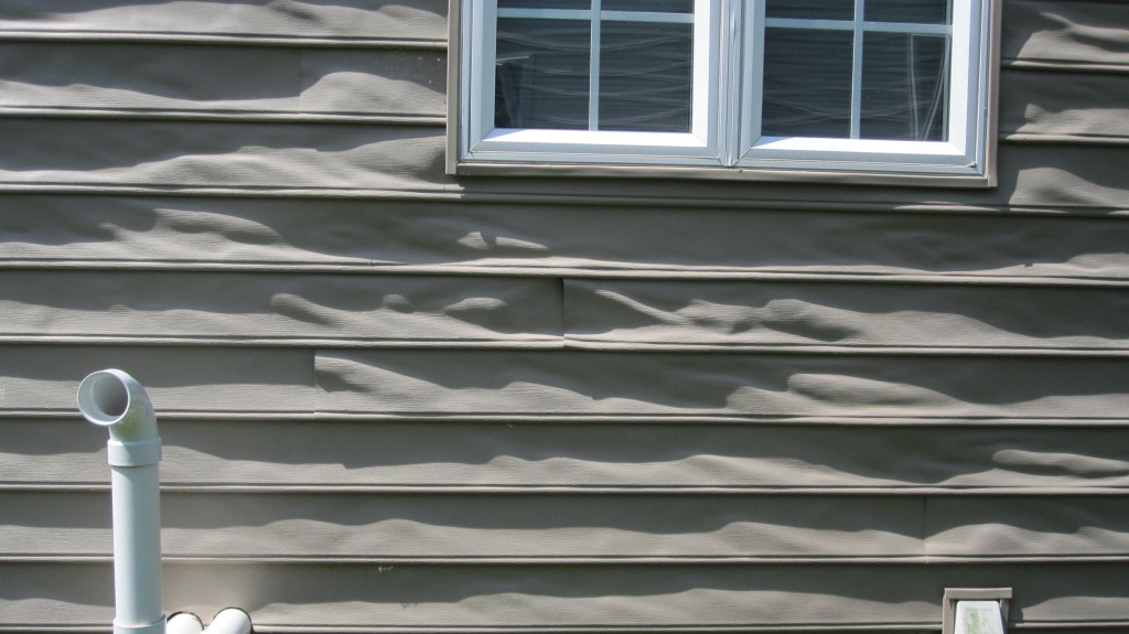 Photo of Melting Vinyl Siding from http://armchairbuilder.com/resources/how-to-build-your-own-home