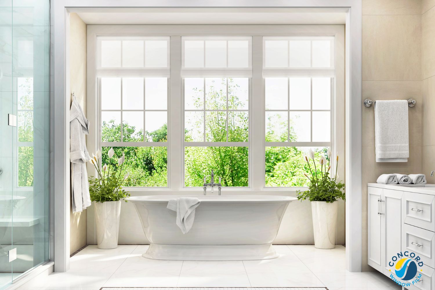 A photo of a bank of three double hung windows above a soaking tub in a bathroom for a post on tempered glass window film