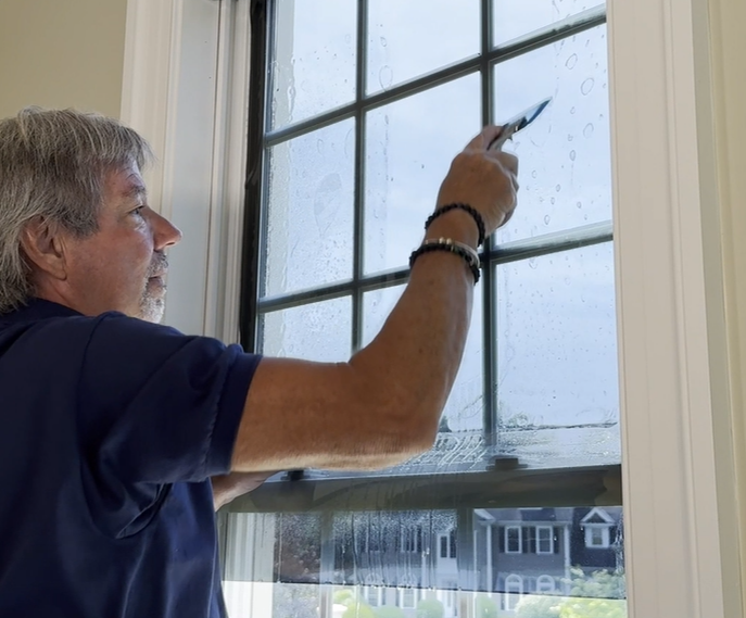 Squeegeeing Film As Part Of Home Window Film Installation